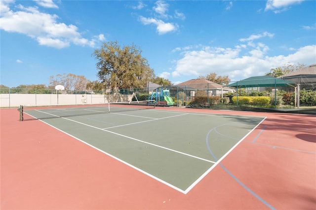 view of sport court featuring a playground and basketball hoop