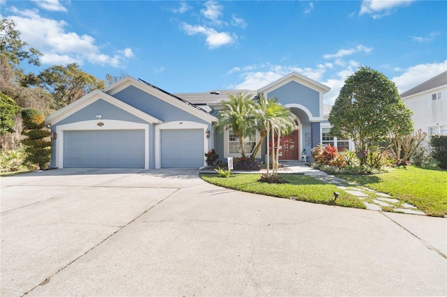 view of front facade featuring a garage and a front lawn