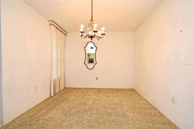 unfurnished room with carpet floors and a notable chandelier