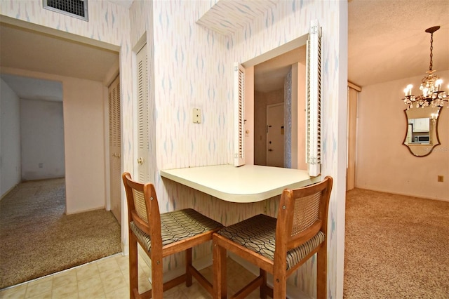 dining space with light colored carpet and an inviting chandelier