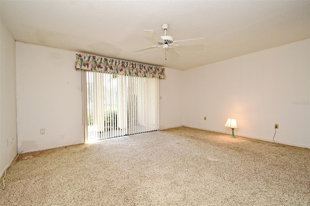 empty room with ceiling fan and a textured ceiling