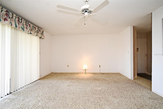 spare room featuring ceiling fan and carpet