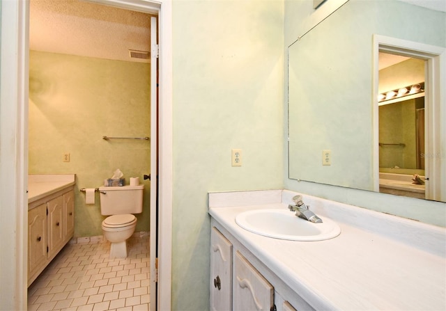 bathroom with visible vents, toilet, a textured ceiling, tile patterned flooring, and vanity