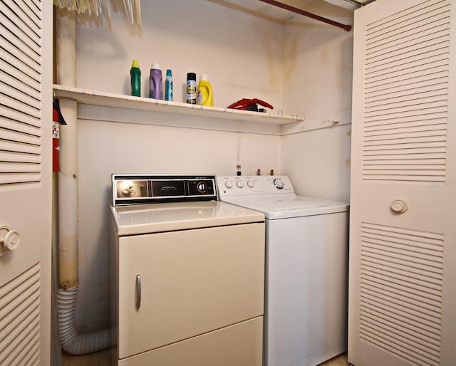 clothes washing area with washing machine and clothes dryer