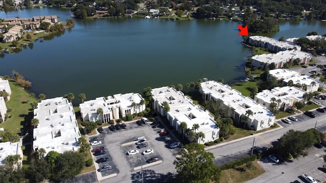 drone / aerial view featuring a residential view and a water view