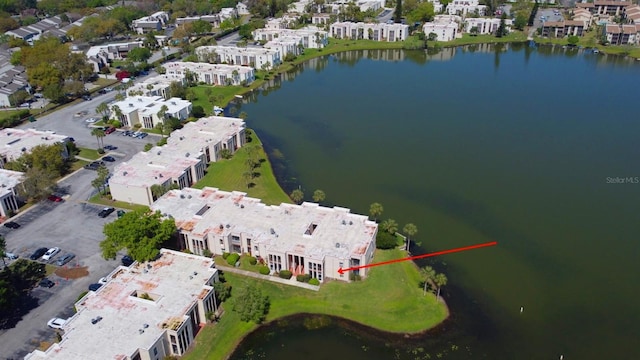 birds eye view of property with a water view and a residential view