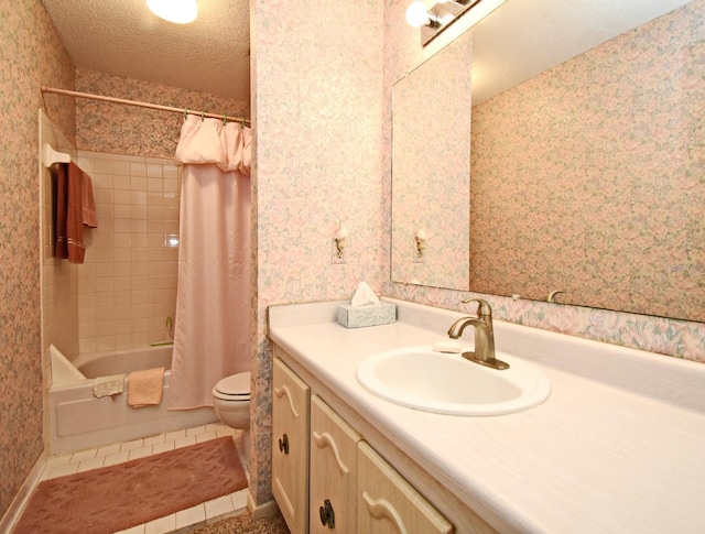 bathroom featuring vanity, a textured ceiling, toilet, and wallpapered walls