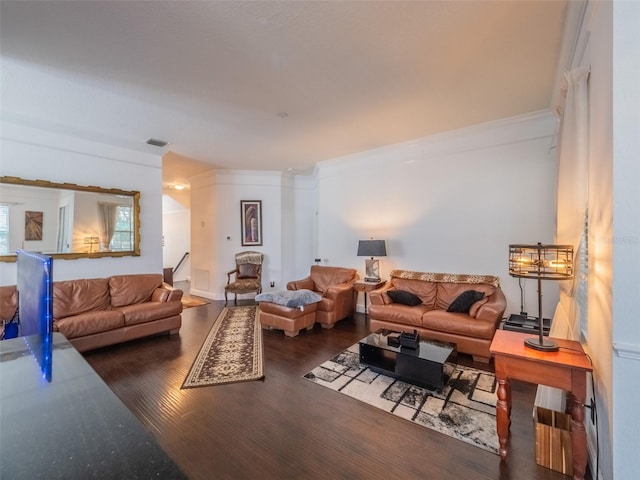 living room featuring ornamental molding and dark hardwood / wood-style floors