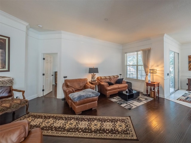 living room featuring crown molding and hardwood / wood-style flooring