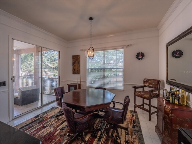 tiled dining room with crown molding, plenty of natural light, and an inviting chandelier