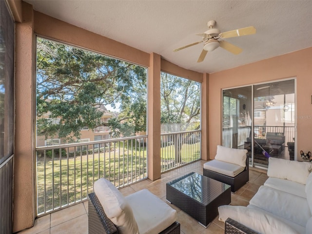 sunroom / solarium featuring ceiling fan