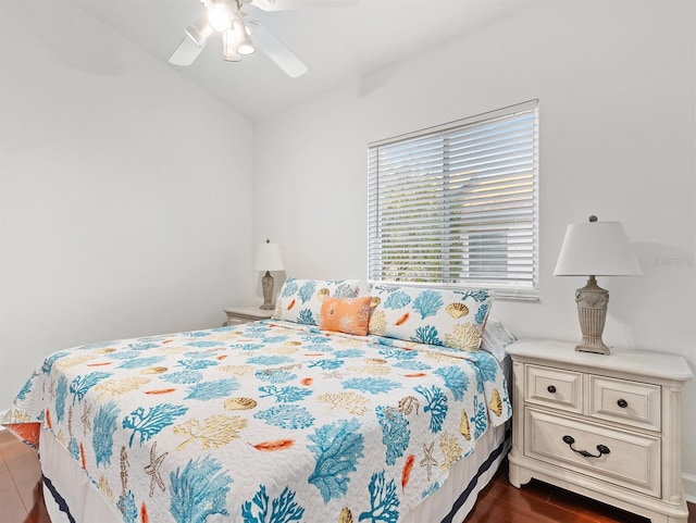 bedroom featuring lofted ceiling, dark hardwood / wood-style floors, and ceiling fan