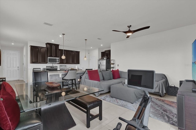 living area with recessed lighting, ceiling fan, and light tile patterned floors