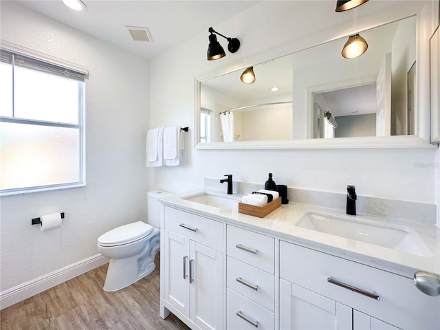 bathroom with hardwood / wood-style flooring, vanity, toilet, and a shower with shower curtain