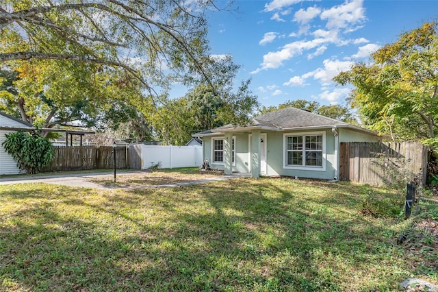 rear view of house with a yard