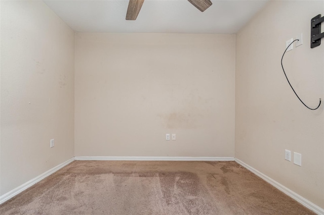 carpeted spare room with ceiling fan