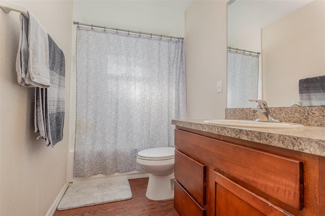 full bathroom with vanity, hardwood / wood-style floors, toilet, and shower / tub combo with curtain