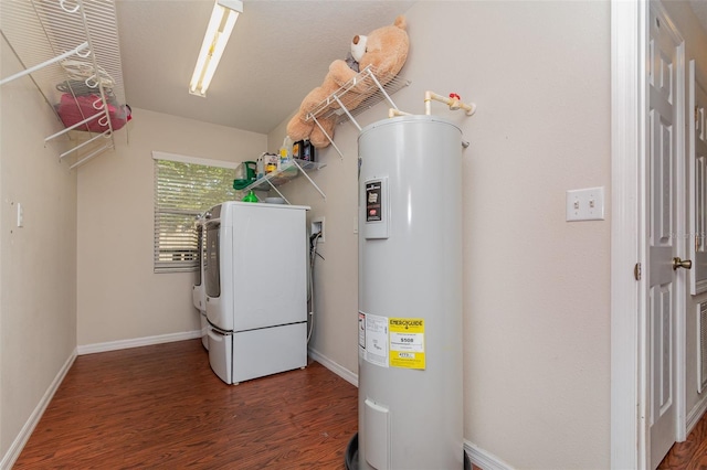 laundry area with dark hardwood / wood-style flooring, washer / dryer, and electric water heater