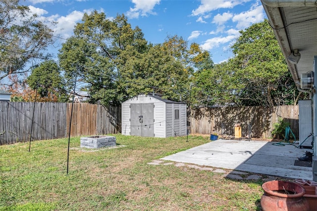 view of yard with a storage shed and a patio