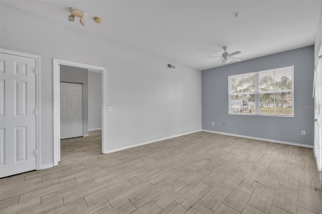 spare room featuring light hardwood / wood-style floors and ceiling fan