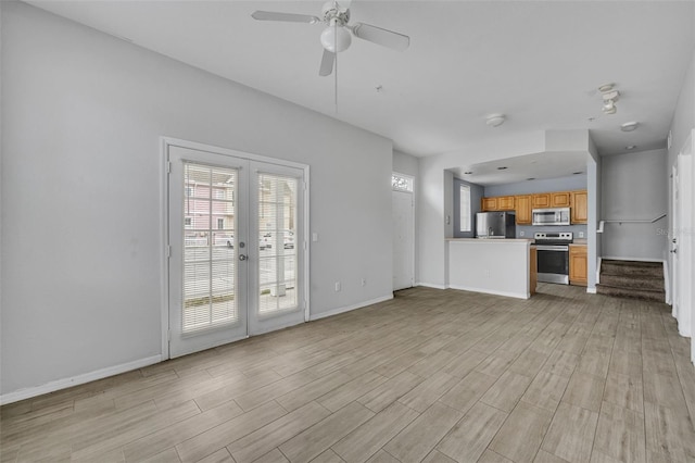 unfurnished living room with ceiling fan and light hardwood / wood-style flooring