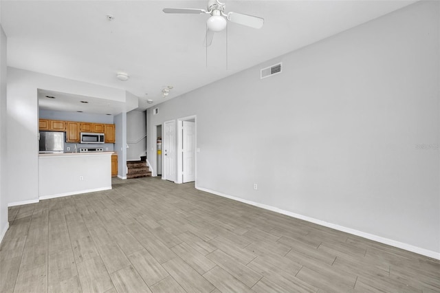 unfurnished living room with light hardwood / wood-style floors and ceiling fan