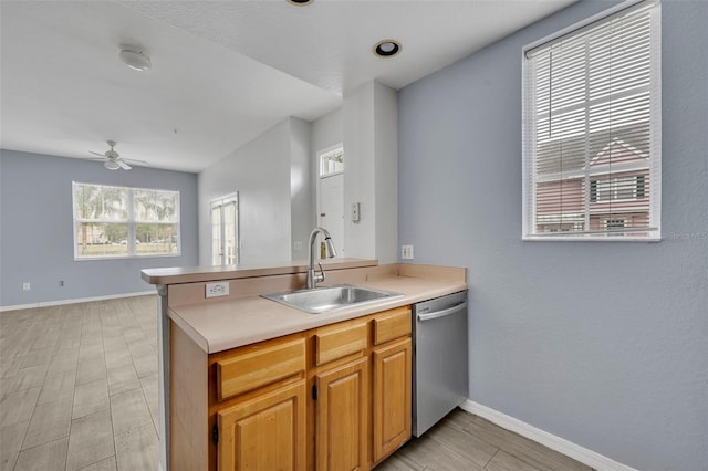 kitchen with dishwasher, sink, ceiling fan, and kitchen peninsula