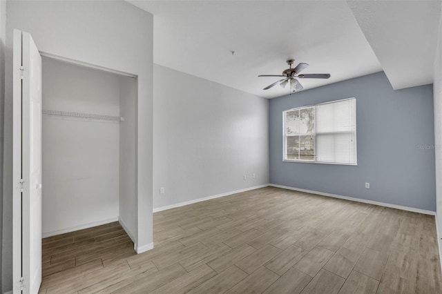 unfurnished bedroom with ceiling fan, light hardwood / wood-style floors, and a closet