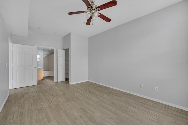 unfurnished bedroom with ceiling fan, ensuite bath, and light hardwood / wood-style flooring