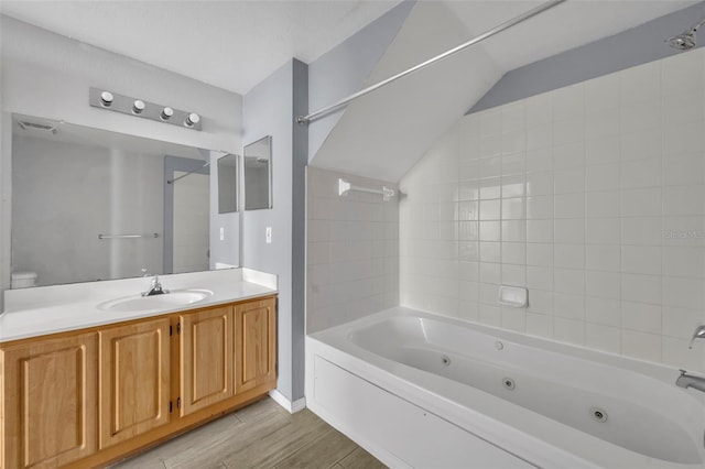 bathroom featuring vanity, tub / shower combination, and lofted ceiling