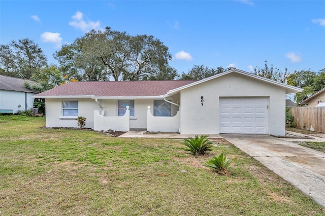 ranch-style home with a garage and a front lawn