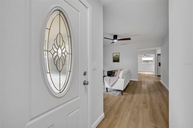 entryway featuring ceiling fan, a healthy amount of sunlight, and light hardwood / wood-style floors