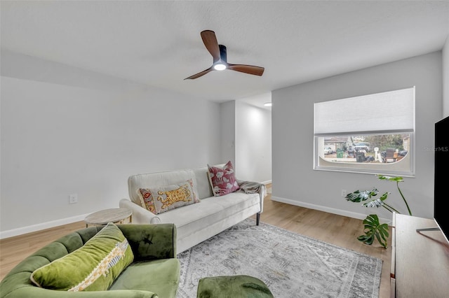 living room with hardwood / wood-style floors and ceiling fan