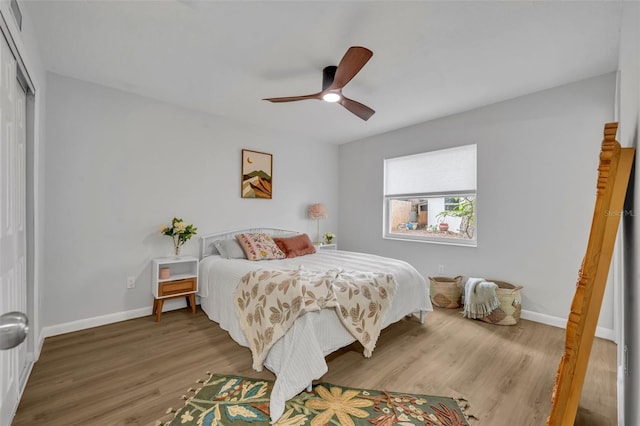 bedroom with wood-type flooring, a closet, and ceiling fan