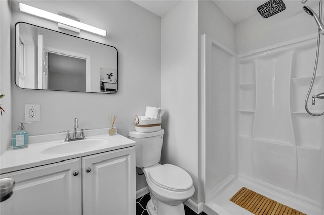 bathroom featuring walk in shower, vanity, and toilet