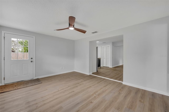 interior space featuring a textured ceiling, ceiling fan, and light hardwood / wood-style flooring