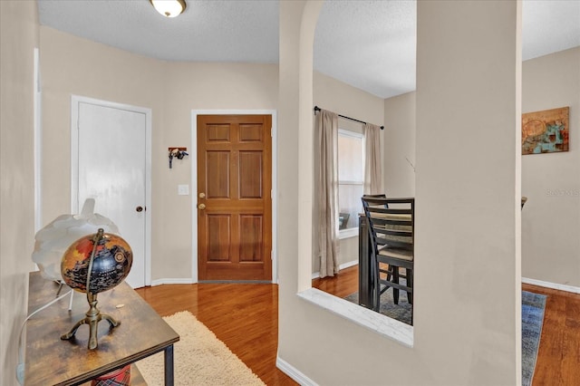 entrance foyer featuring hardwood / wood-style floors and a textured ceiling