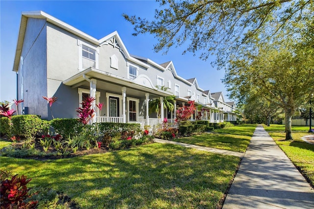 view of front of home featuring a porch and a front lawn