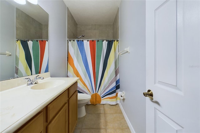 bathroom featuring tile patterned floors, toilet, and vanity