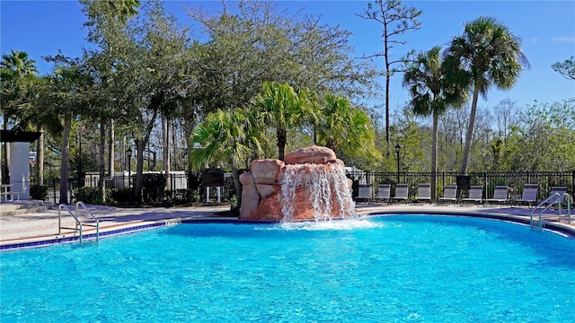 view of swimming pool with pool water feature