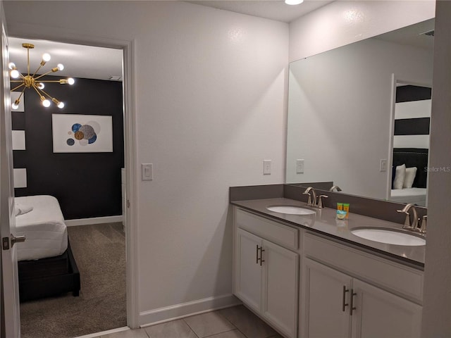 bathroom featuring tile patterned flooring, vanity, and a chandelier