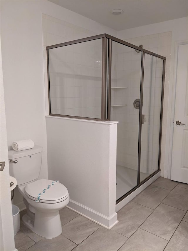 bathroom featuring walk in shower and toilet