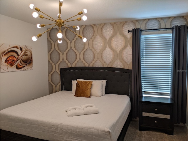 bedroom with an inviting chandelier and dark carpet