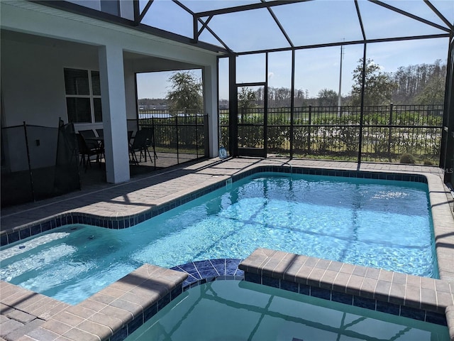 view of swimming pool featuring a patio and glass enclosure