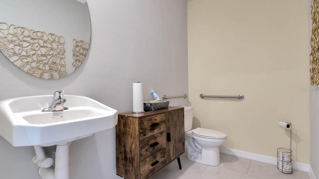 bathroom with toilet and tile patterned flooring