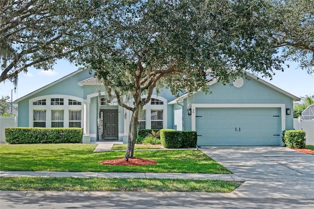 view of front of home with a garage and a front lawn