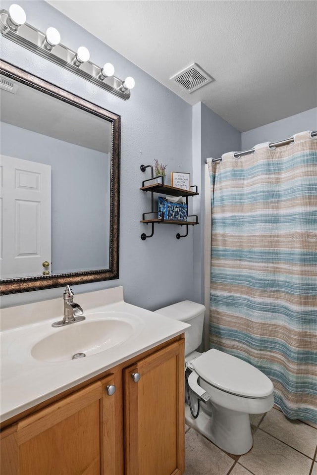 bathroom with vanity, toilet, tile patterned floors, a textured ceiling, and a shower with curtain
