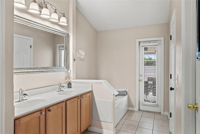 bathroom featuring vanity, a tub, and tile patterned floors