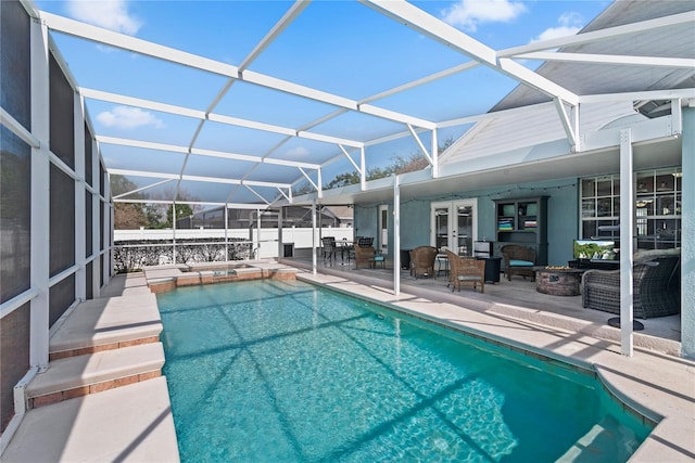view of swimming pool featuring a lanai, an outdoor living space, a patio area, french doors, and an in ground hot tub
