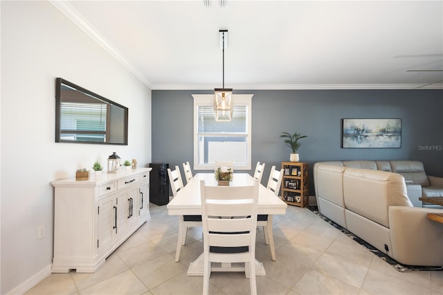 dining room with light tile patterned floors and crown molding